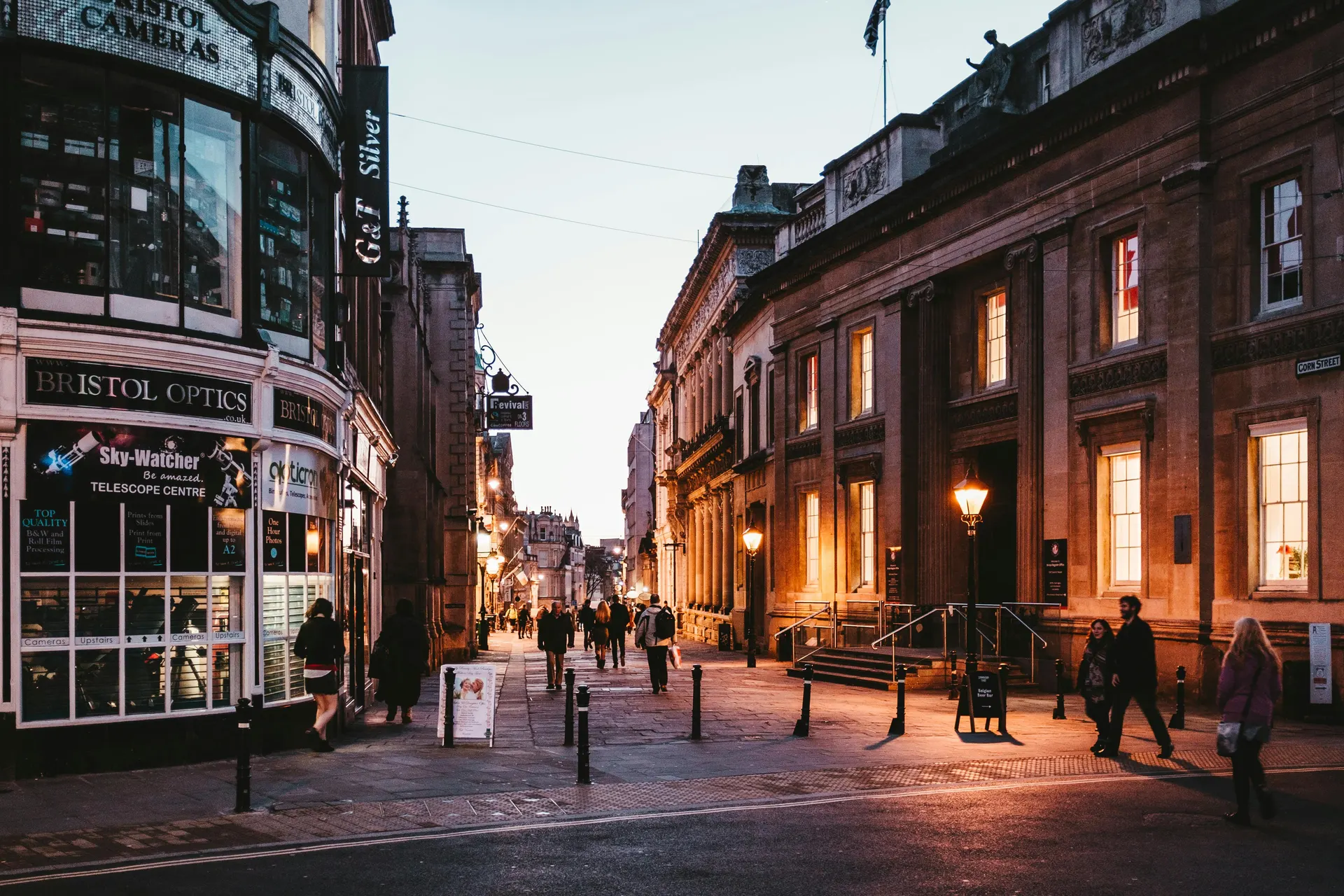 Travellers navigating a modern English city street